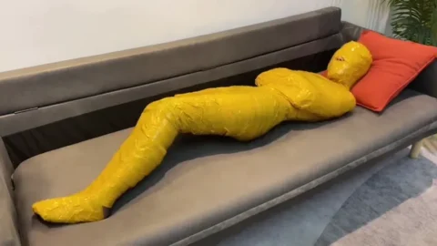 Mummified With Duct Tape On A Sofa