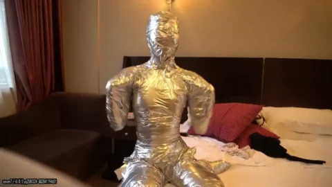 This Girl Is Wrapped In Chrome Duct Tape In Frogtied Position
